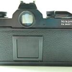 Black Nikon FM SLR film camera; body only, no lens.