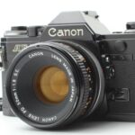 Canon AE-1 35mm SLR Film Manual Focus Camera (Black) with 50MM Canon FD mount lens. (Renewed)